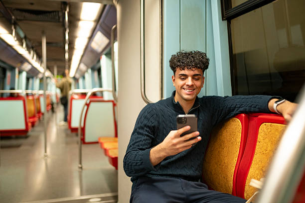 istock Teenager sitting using smartphone on the metro 2221147947