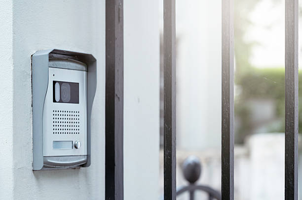 istock A control panel is mounted on a white wall beside a wrought iron gate, showing a sleek design for entry communication 2221148800