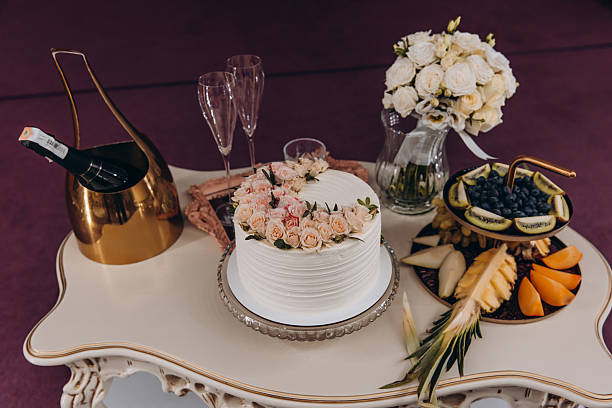 istock White Wedding Cake with Peach Roses on Elegant Dessert Table 2221149221