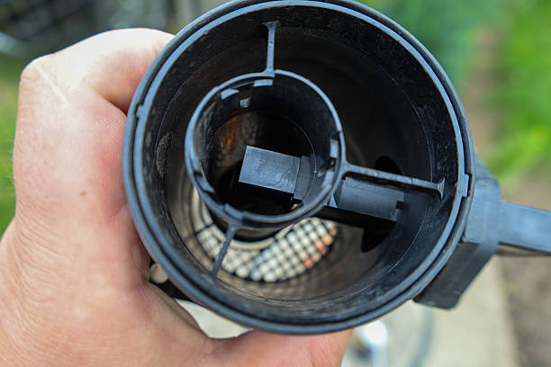 istock A hand holds an automotive engine component, likely a mass airflow sensor, revealing its internal structure. This element is crucial for proper engine operation, controlling airflow. 2221150160