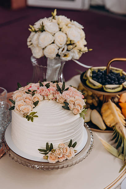 istock Close-Up of White Wedding Cake with Peach Roses 2221151084