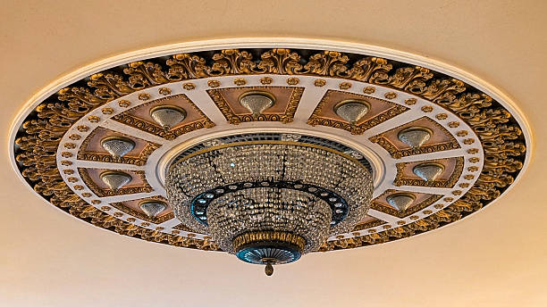 istock Luxurious theater ceiling featuring a large crystal chandelier and intricate decorative plasterwork 2221152303