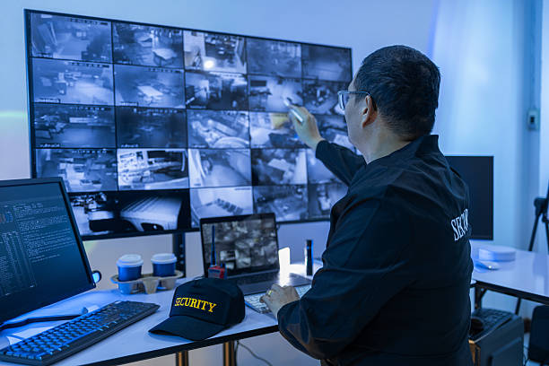 istock Security Man guard, Working in Control room by cctv monitor for protection, data center or building safety. Inspection, video surveillance agency and control room with footage, View Monitor and computer 2221152425