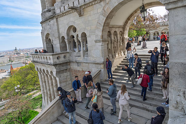 Buda, Budapest, Hungary - April, 2025:  Fishermen's Bastion in Buda, Budapest.  There are tourists on the walls around the Bastion.