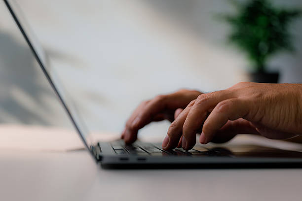 istock Typing on laptop keyboard with modern office background 2221156931