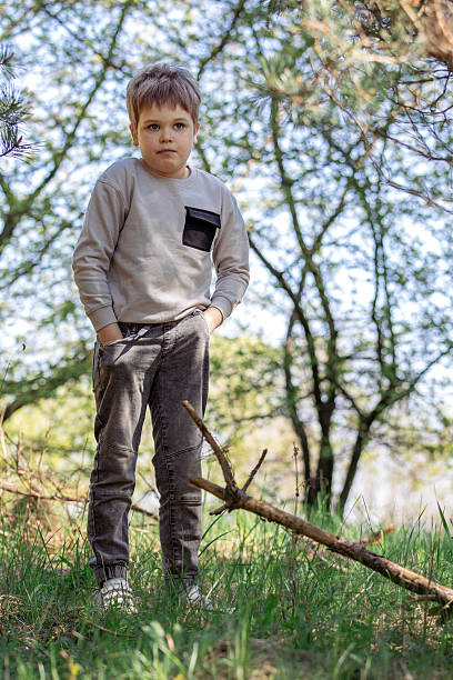 istock A cute little boy searching for something in his pants pockets 2221161100