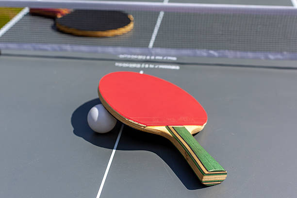 istock Composition on the grey tennis table, High angle view of red racket on table 2221161290