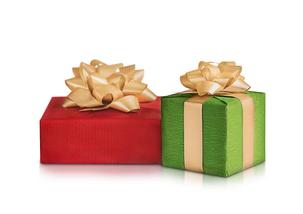 two festive boxes in green and red with gold bows are isolated on a white background