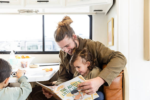 istock Father and Daughter Reading a Book Together in RV 2221172273