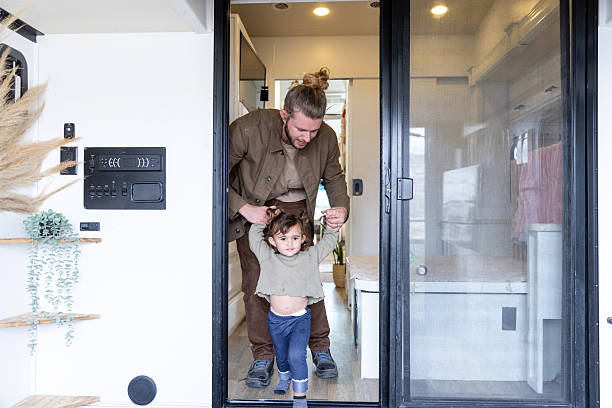istock Father and Toddler Daughter Taking First Steps Outdoors RV 2221172305