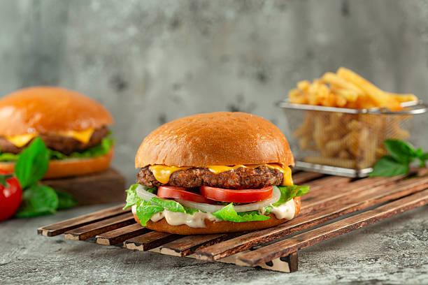 istock Classic burger ( cheese burger ) with french fries. 2221178210