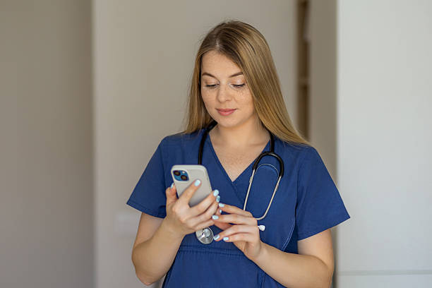 istock Healthcare professional in uniform checking smartphone at work 2221179301