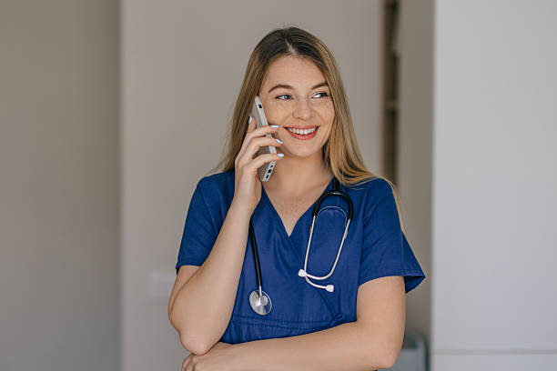 istock Smiling nurse with stethoscope talking on phone in a healthcare setting 2221179317