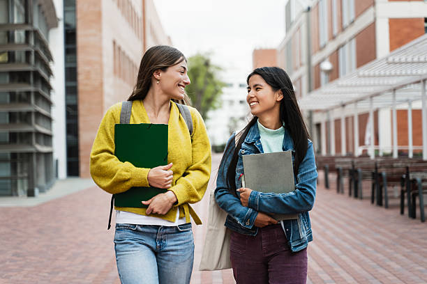 istock Cheerful multiracial student girls walking and talking at university Campus after classes 2221181482