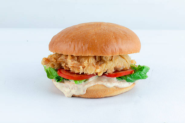 Crispy burger crispy chicken burger with sauce and vegetables isolated on white background.