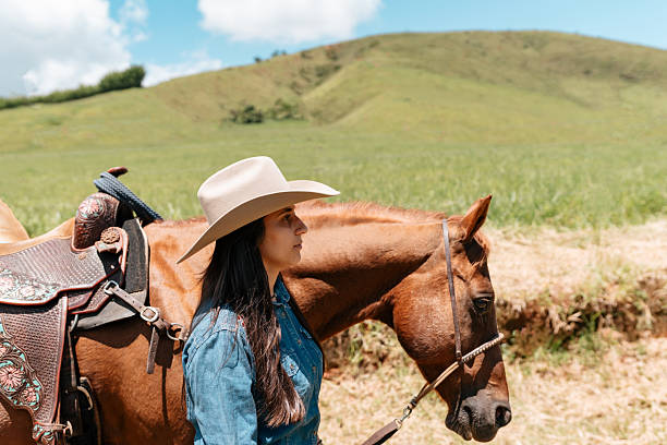 Cowgirl walking alongside horse