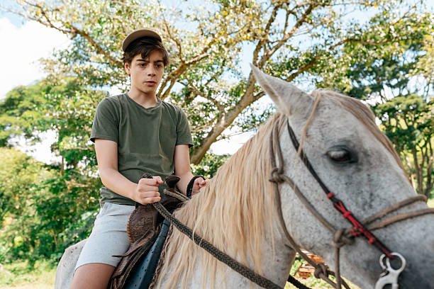 Young rider learning to control horse