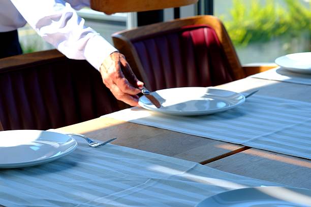 istock Waiters preparing the table for dinner service in a luxury restaurant. 2221184363
