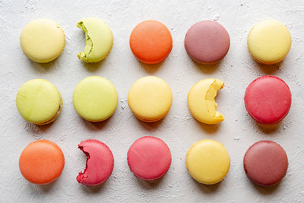 French Macarons in Orderly Rows, Top View on White