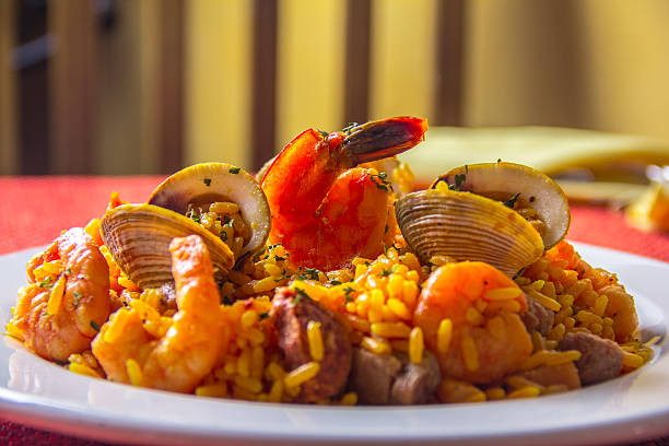 istock A splendid dish featuring a blend of seafood, including shrimp and clams, served over saffron-infused rice, emphasizing the freshness and culinary art behind the paella. 2221188770