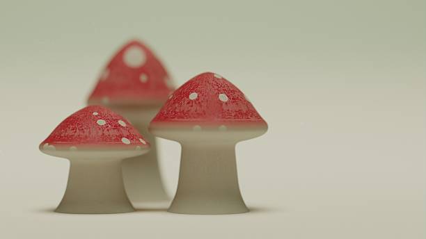 istock Three red mushrooms with white spots on pale background 2221189542