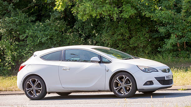 Milton Keynes,Bucks,UK - June 16th 2025: 2012 white Vauxhall Astra car driving on a British road