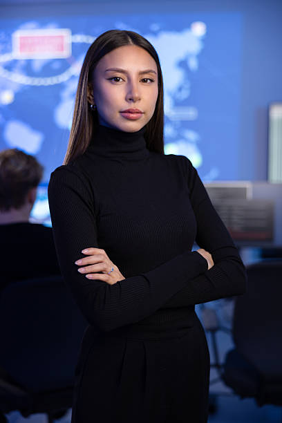 istock Serious Female Cybersecurity Analyst or Manager in large Cyber Security Operations Center SOC handling Threats 2221189887