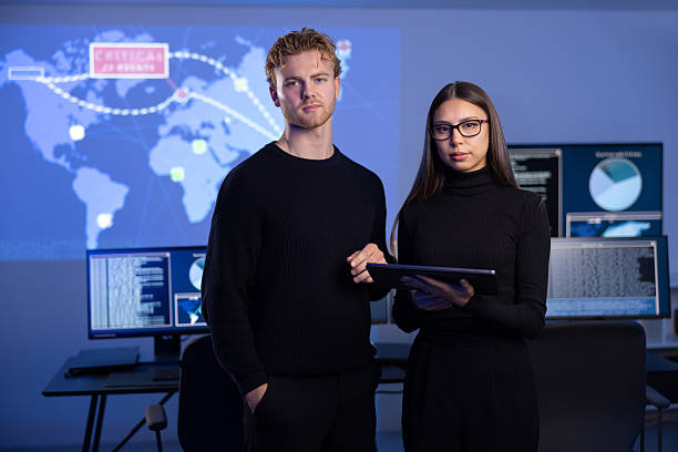 istock Professional and confident cyber security team in front of dark cybersecurity SIEM system with logs and incident map 2221189936