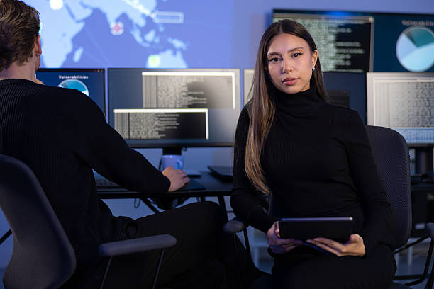 istock Confident female Cybersecurity Analyst or Manager in large Cyber Security Operations Center SOC handling Threats 2221189947