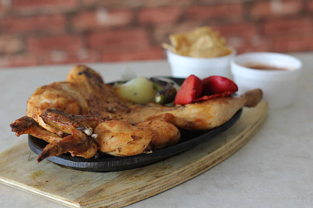 istock This sizzling grilled chicken dish, served with assorted vegetables, illustrates a flavorful culinary experience typical of vibrant grilling culture. 2221191827