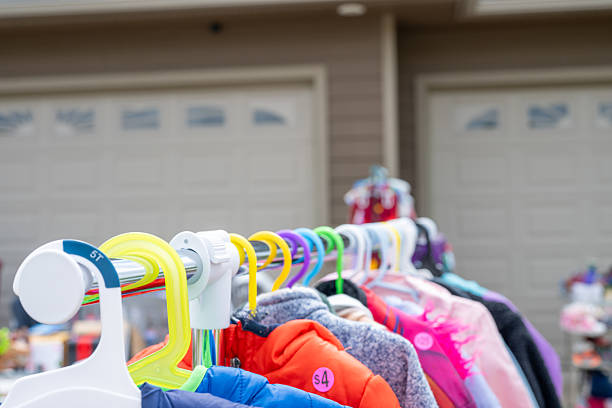 istock Clothes rack with hangers and assorted items at a garage sale 2221196058