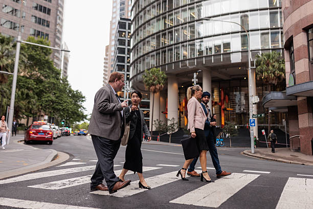 istock Business Colleagues Chatting While Walking Across Crosswalk in Sydney 2221196161