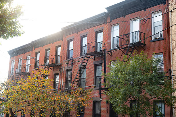 This is a photograph of a row of red brick residential buildings in Brooklyn Heights NYC on an autumn day.