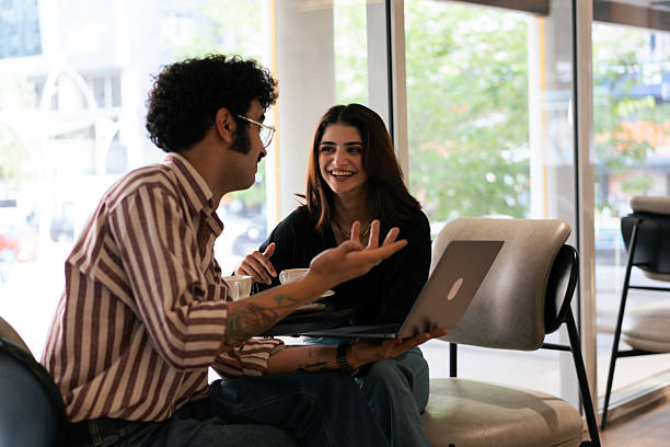 istock Young colleagues sharing ideas during coffee break in modern office 2221196290