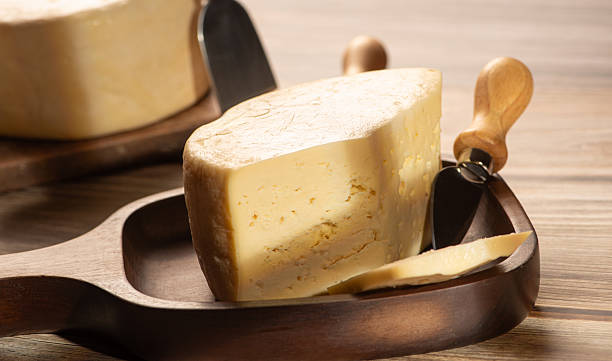 istock Minas Cheese, Delicious semi-cured cheese from Minas Gerais, Brazil, on rustic wood, selective focus. 2221197314