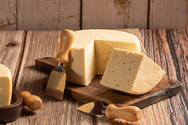 istock Minas Cheese, Delicious semi-cured cheese from Minas Gerais, Brazil, on rustic wood, selective focus. 2221197322