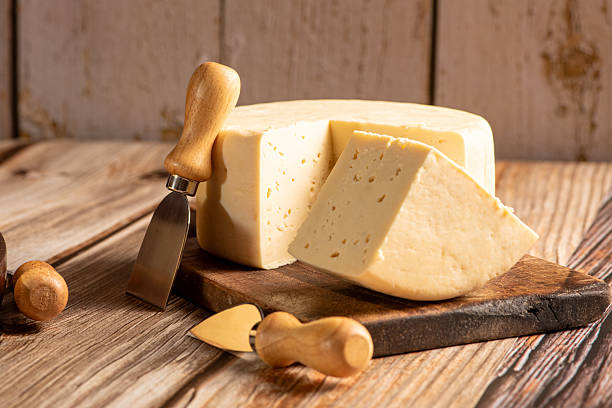 istock Minas Cheese, Delicious semi-cured cheese from Minas Gerais, Brazil, on rustic wood, selective focus. 2221197346