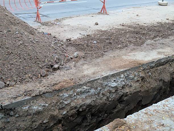 istock Construction work. Laying underground utilities in the city center. Trench and soil dumps for laying utilities 2221202889