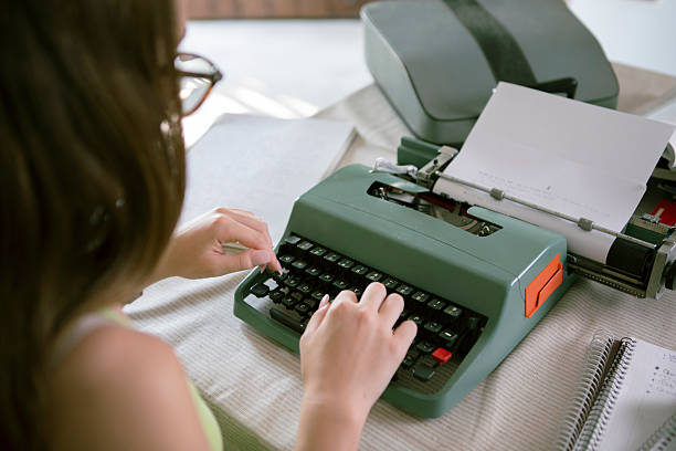 Young woman doing homework on a typewriter