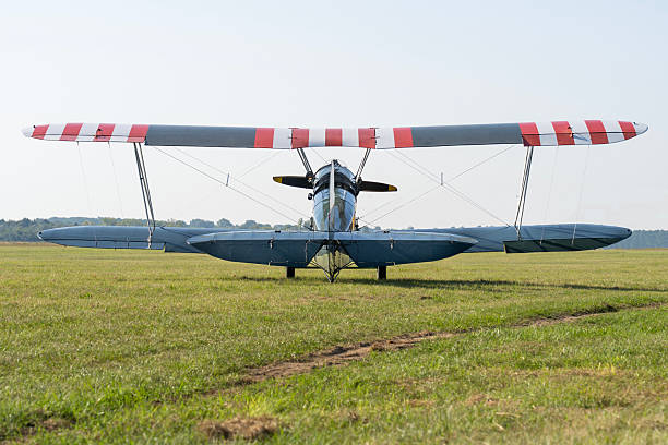 istock Soviet-made World War II green biplane on a grassy airfield 2221206156