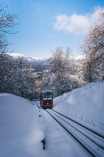 istock Funicular train travels up snow covered mountain 2221207067