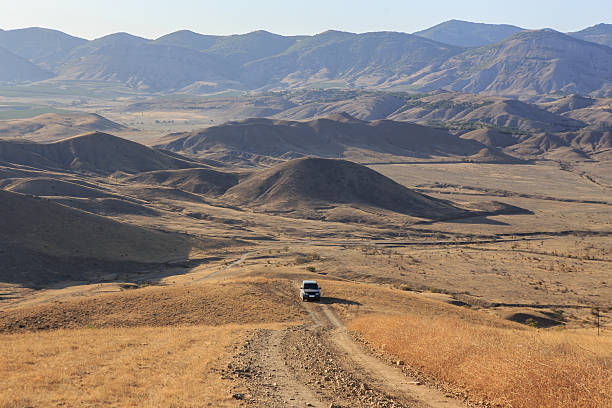 A close-up side view shot of a caucasian man driving to work in his van.