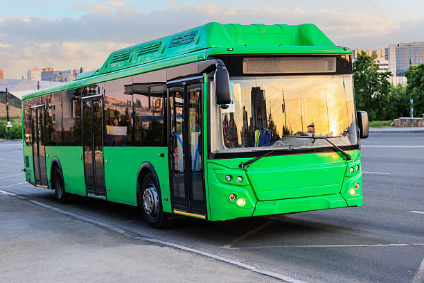 istock City bus moving along the avenue at sunset 2221207426