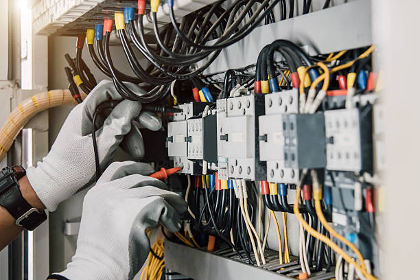 istock Electrician engineer tests electrical installations and wires on relay protection system. 2221208467