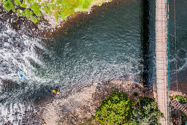 Business people crossing river by double canoe