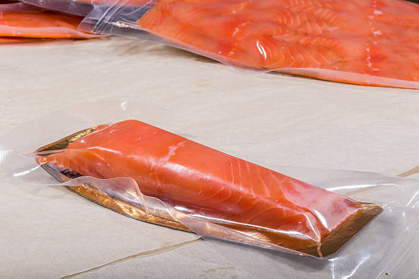 istock Red fish in a sealed vacuum plastic bag. Finished product from production 2221215545