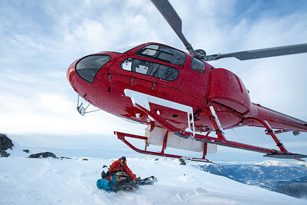 istock Helicopter picks up backcountry skier from mountain 2221216873