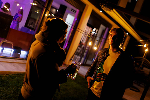 istock Outdoor evening social gathering with string lights and conversations 2221219200