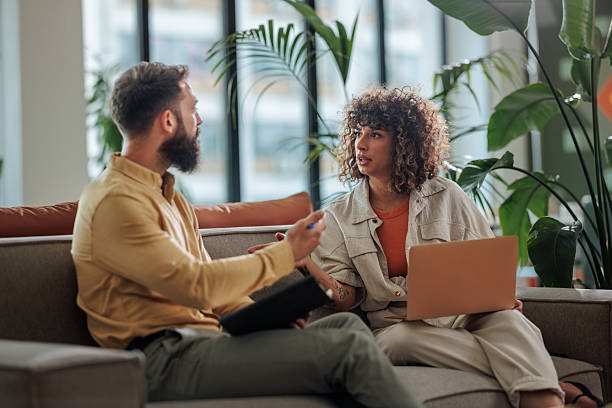 istock Colleagues discussing a project using a laptop in a modern office 2221219674