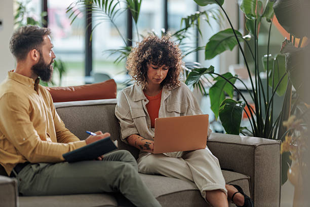 istock Business partners working together on a project using laptop and taking notes 2221219676